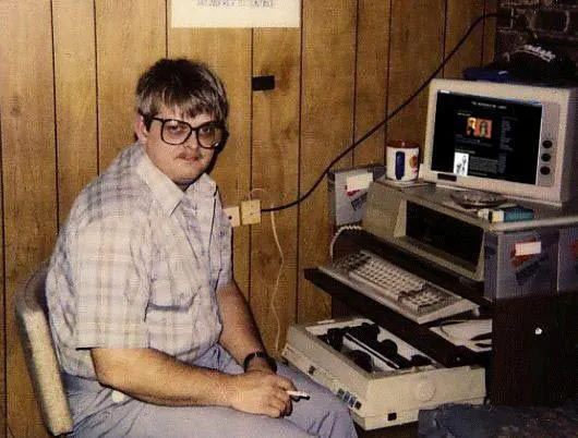 a man sitting in a chair with a computer .png